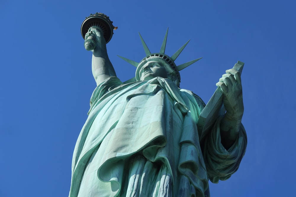 the statue of liberty is shown against a blue sky