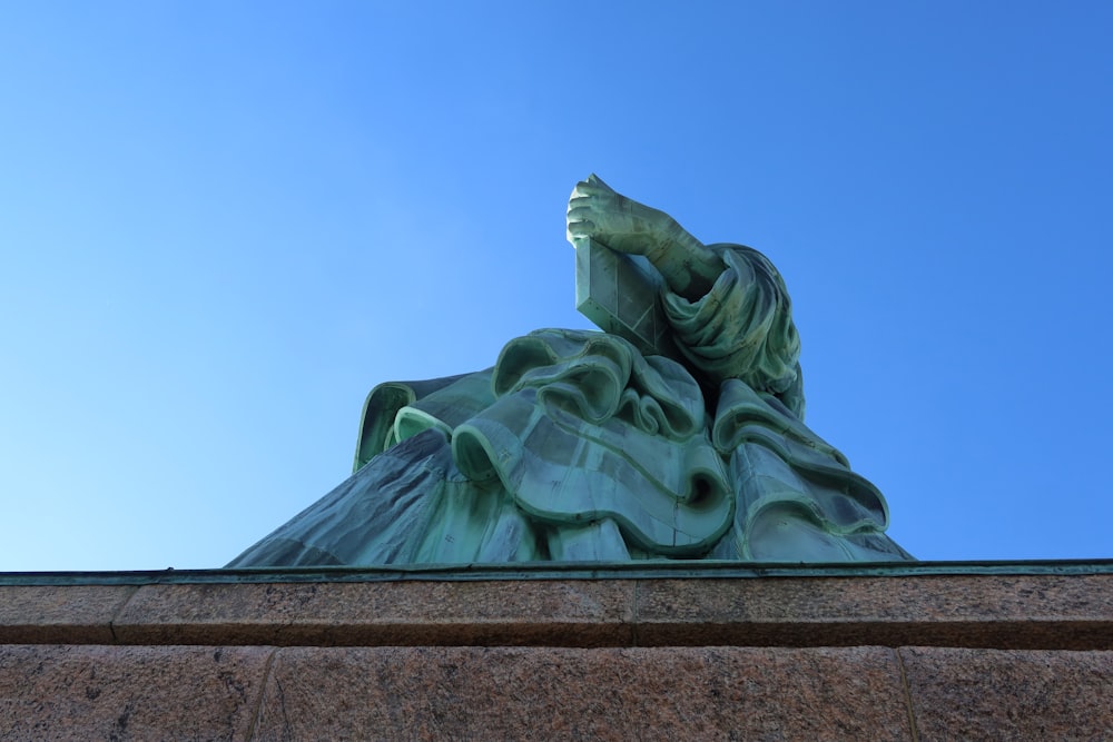 a statue of a woman with her hands on her head