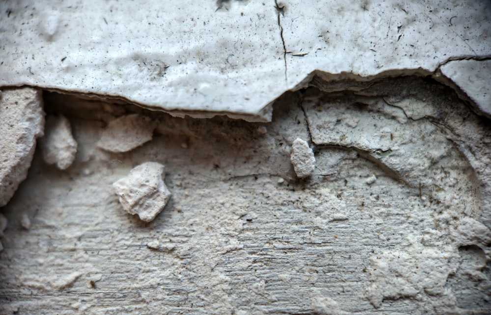 a close up of a stone wall with cracks