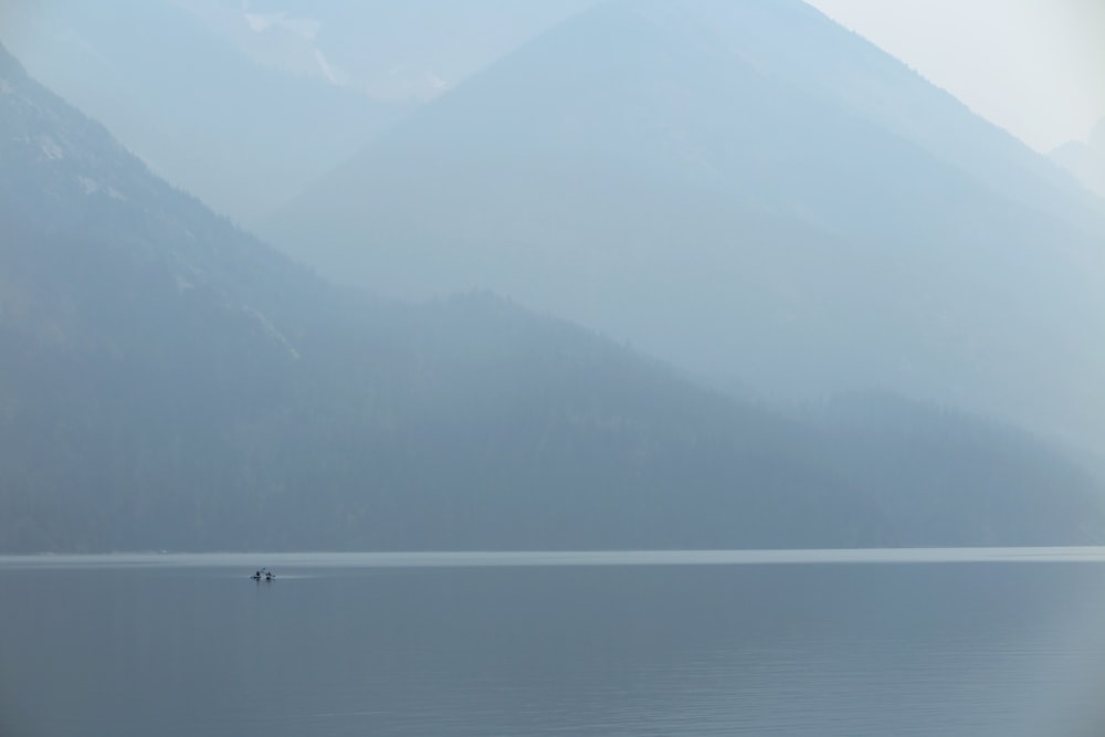 a body of water with mountains in the background