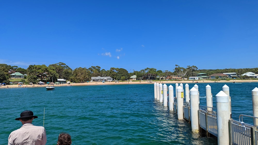 a man and a little girl fishing on a pier