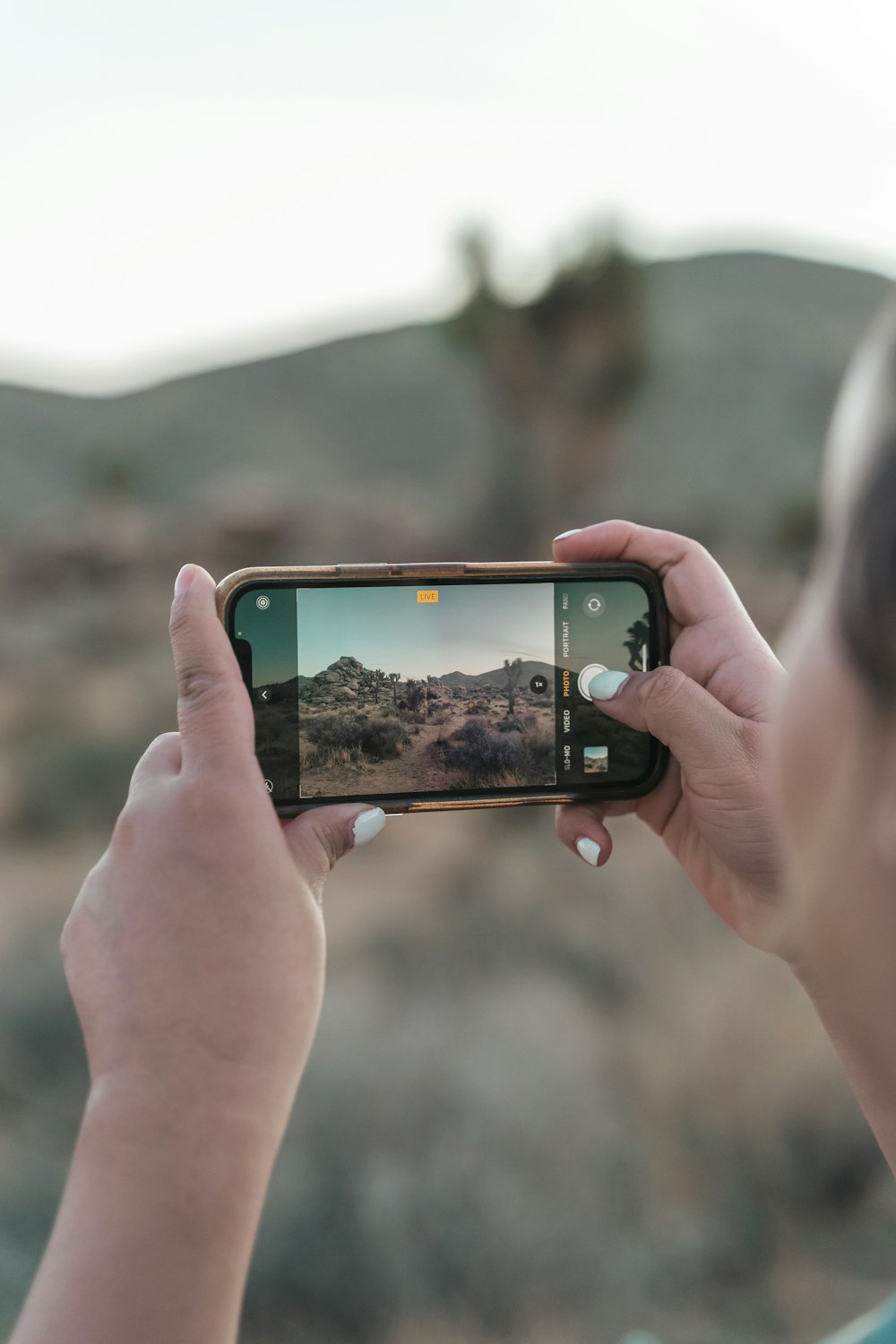 a woman taking a picture with her cell phone