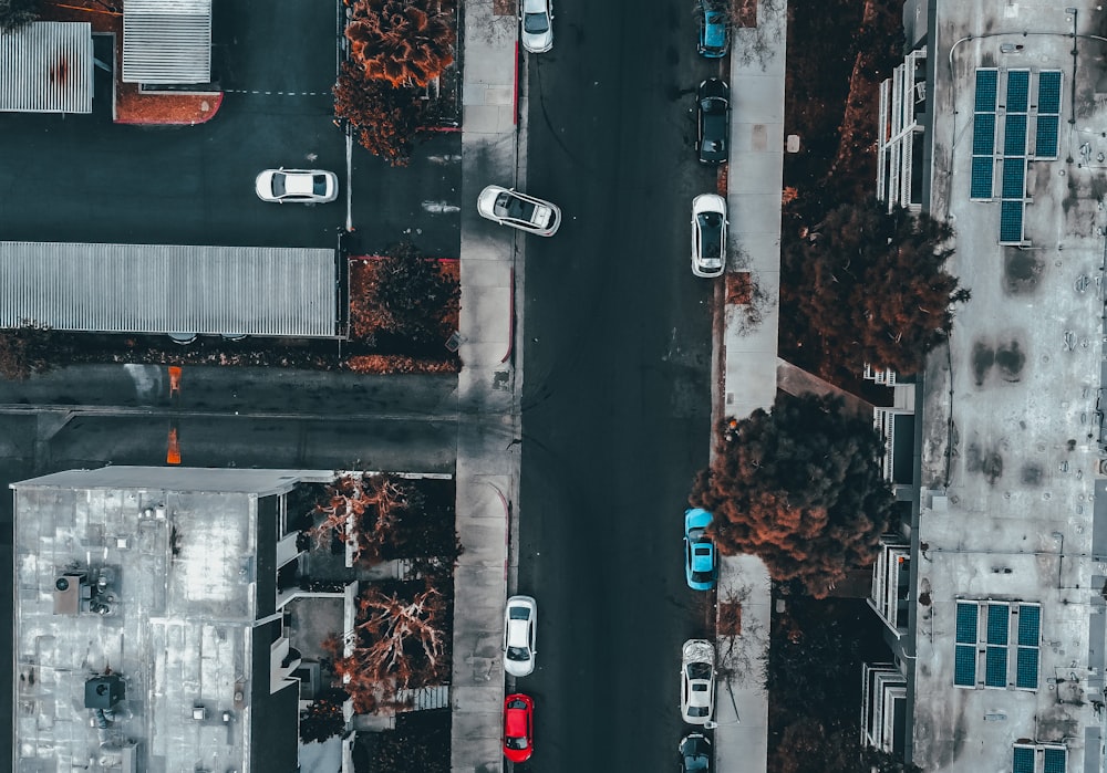 an aerial view of a street with parked cars