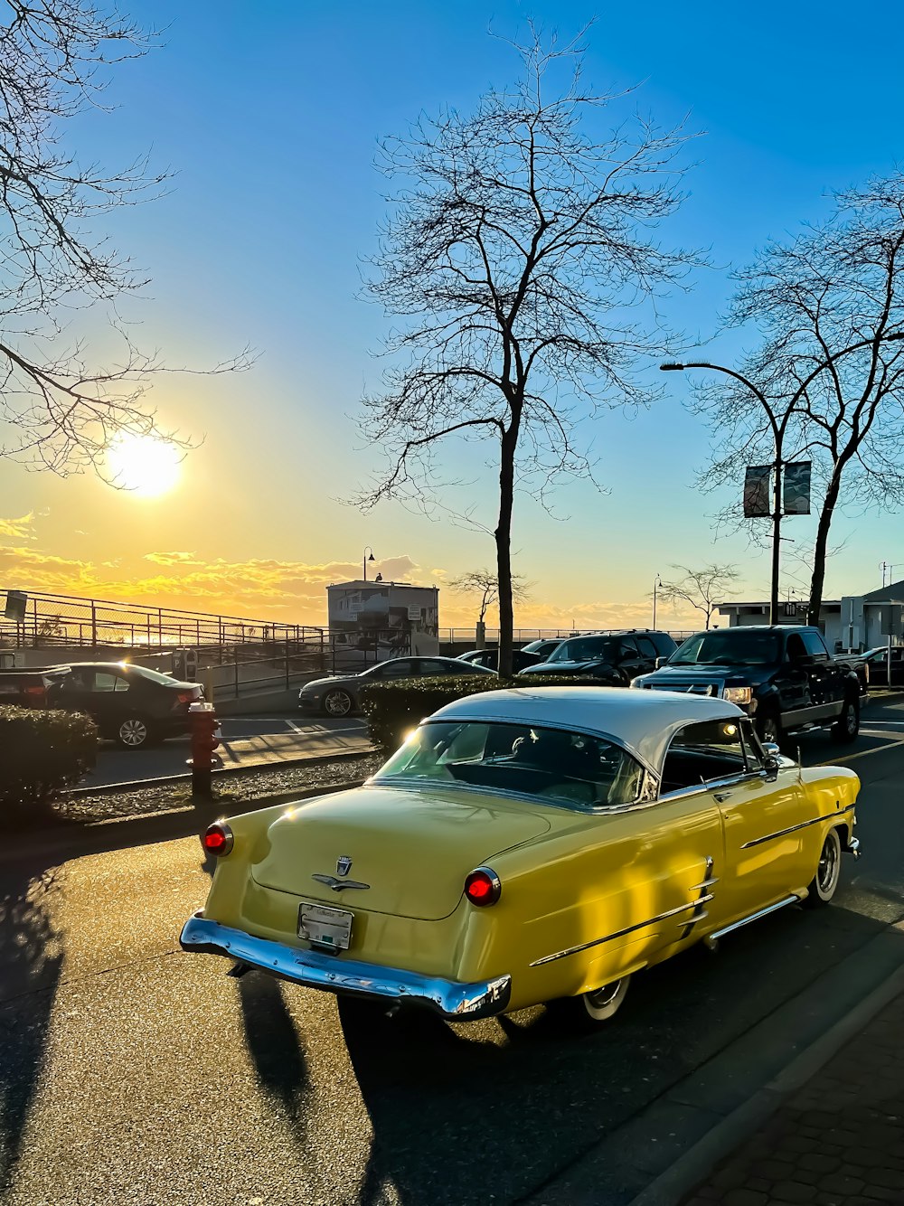 a yellow car parked on the side of the road