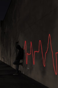 a man leaning in front of a wall with his lifeline on the wall