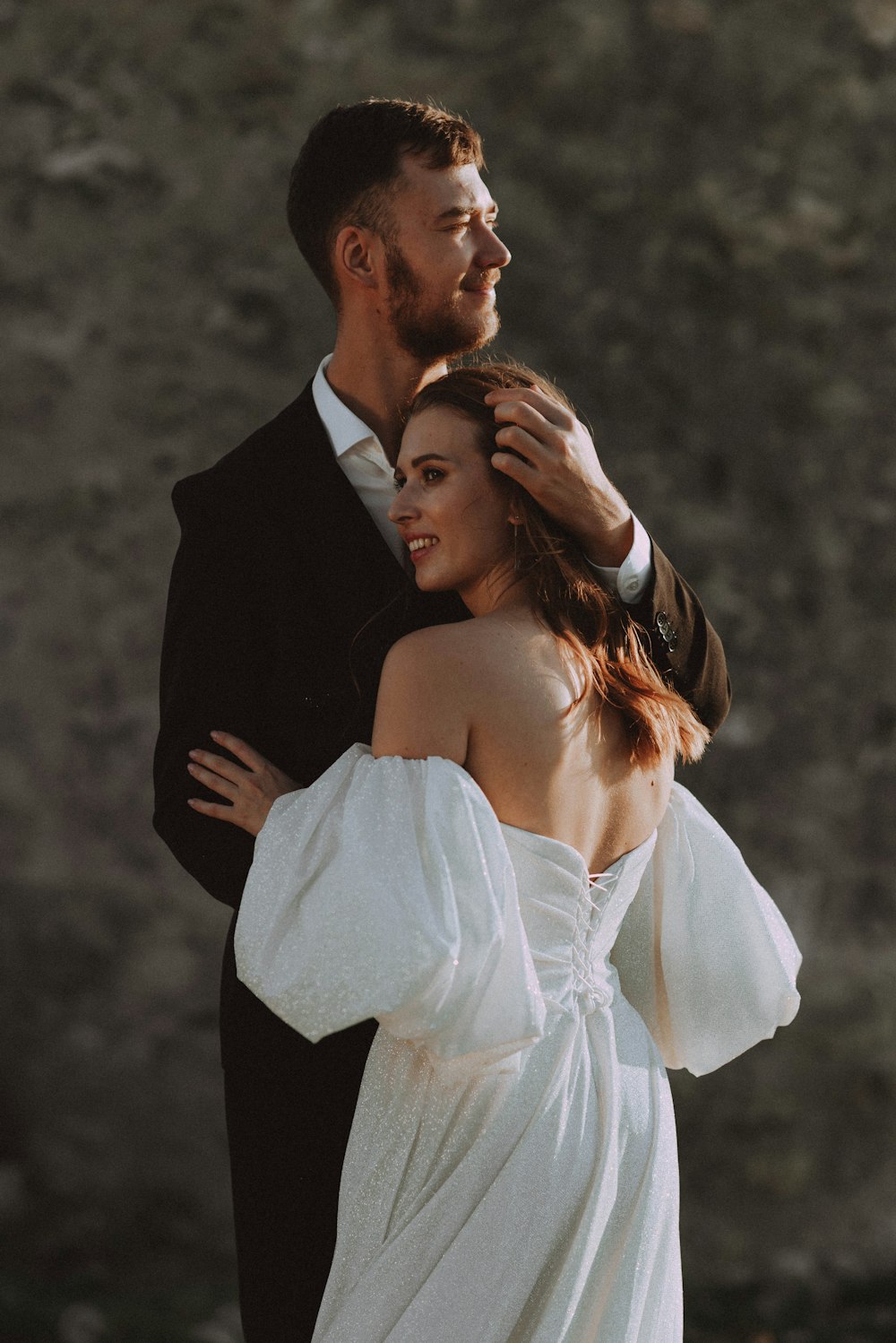 a man in a tuxedo and a woman in a white dress