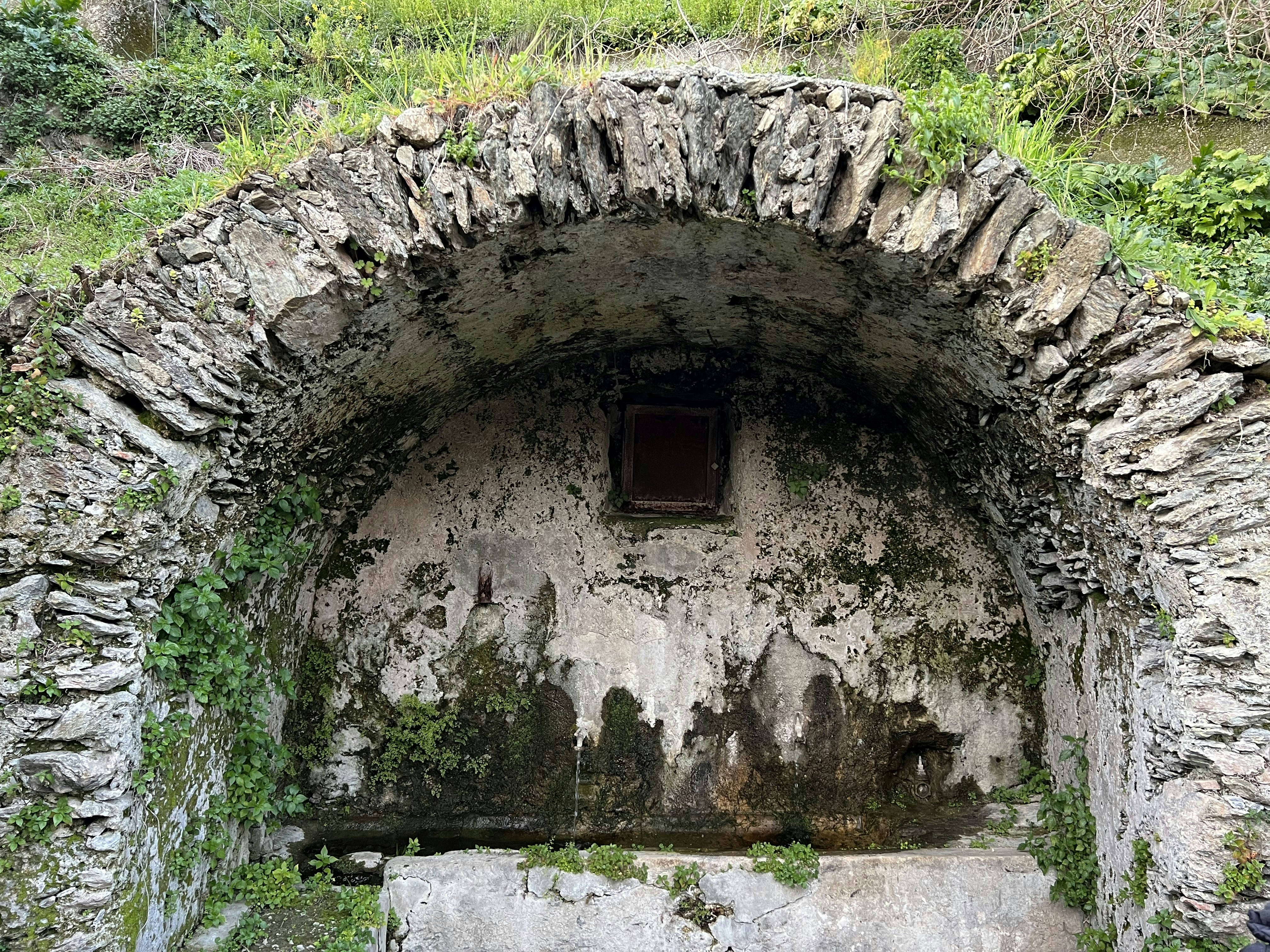 a stone tunnel with a window in it