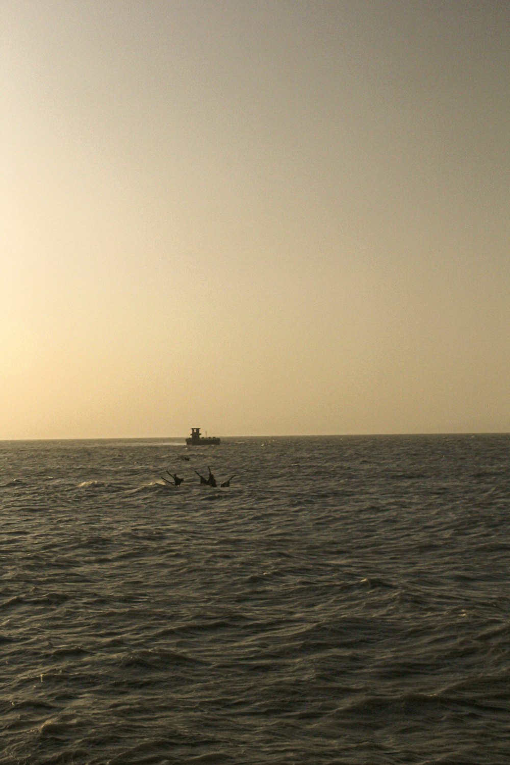 a couple of boats floating on top of a large body of water