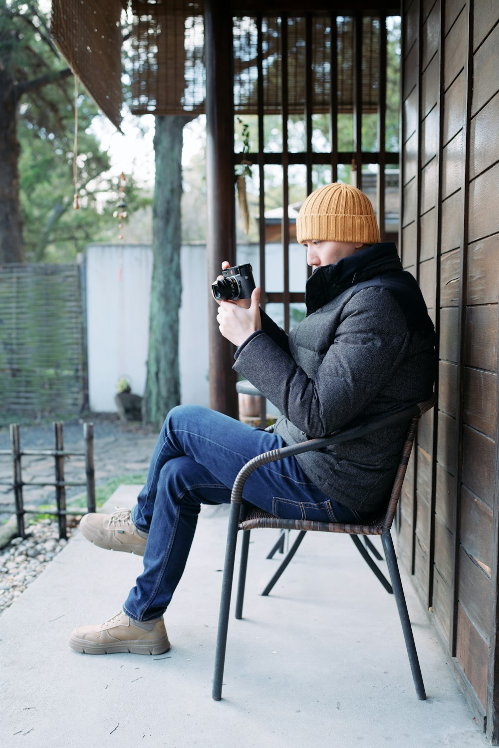 a man sitting in a chair holding a camera