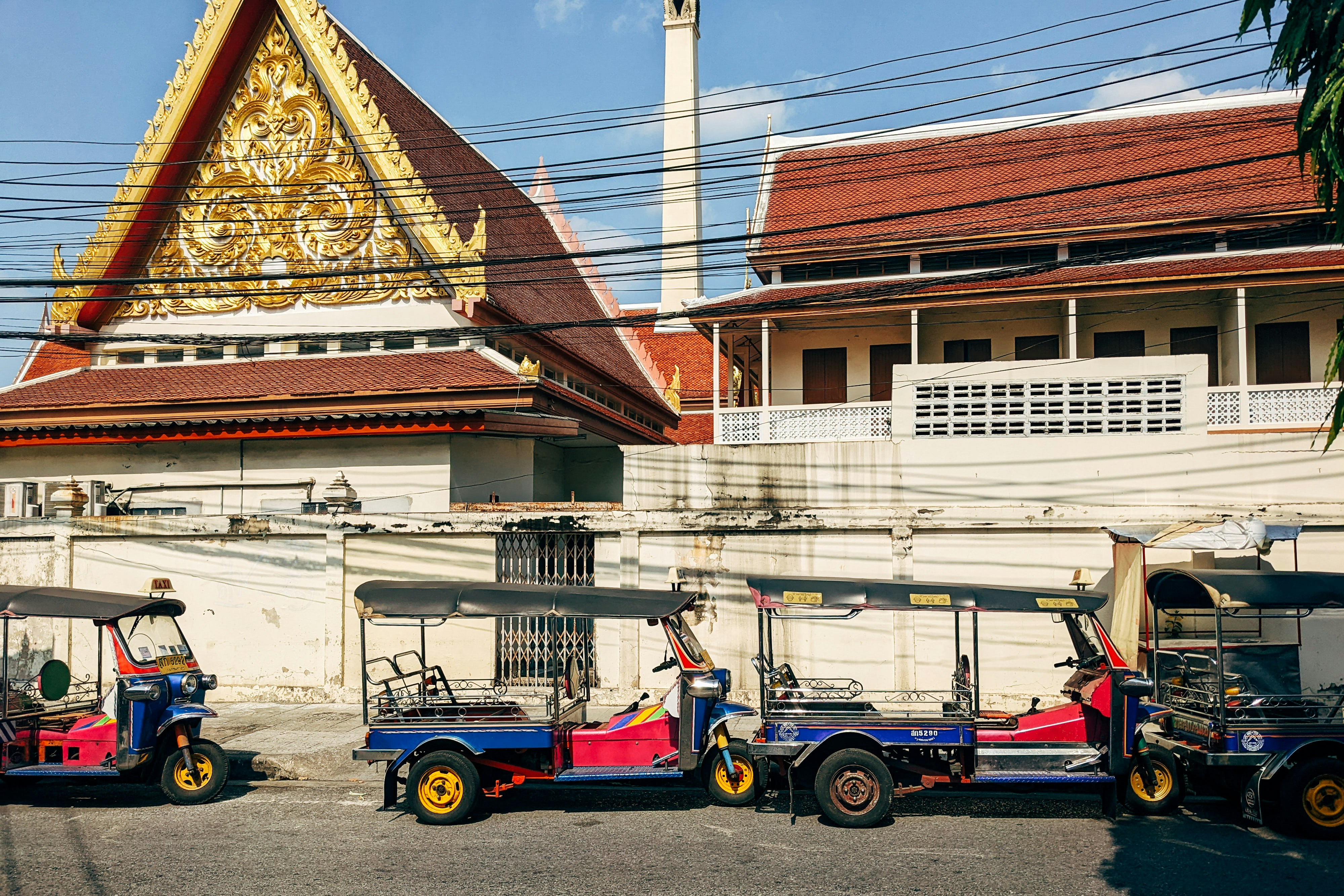 a line of utility vehicles parked in front of a building