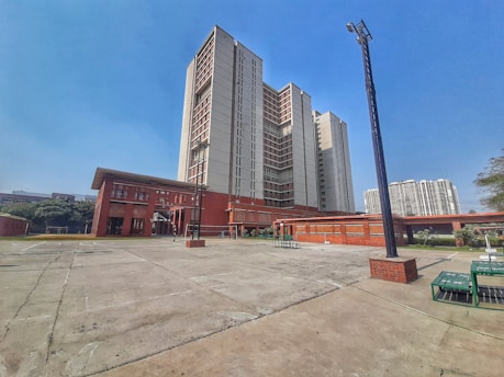 an empty parking lot in front of a large building