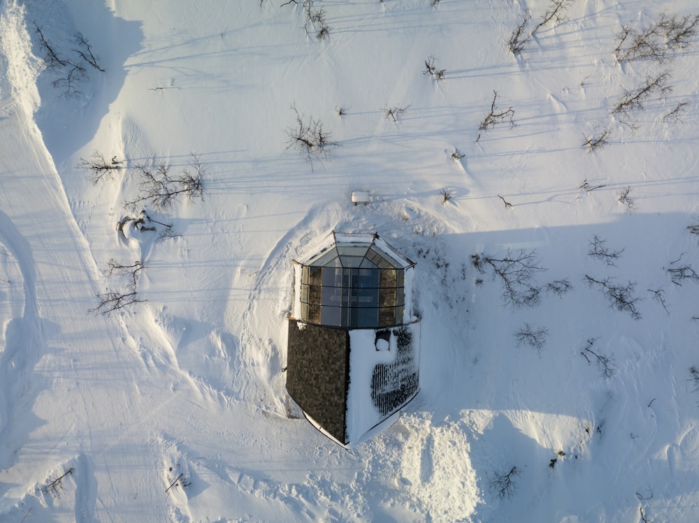 an aerial view of a tower in the snow