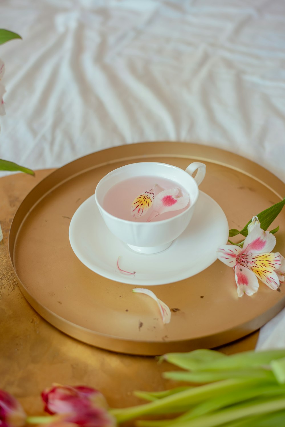 a cup of tea on a tray with flowers