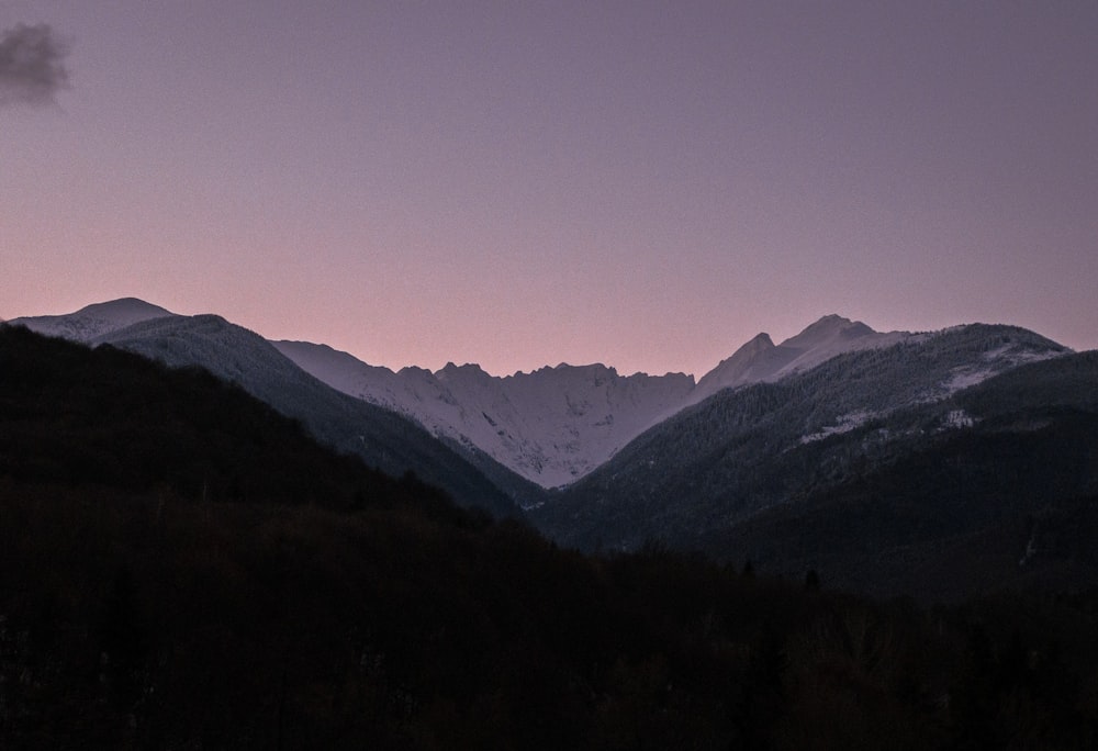 a view of a mountain range at dusk