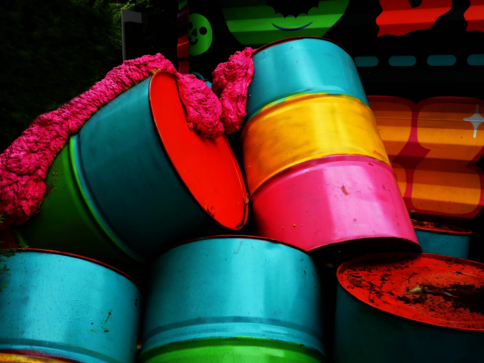A stack of colourful plastic buckets nested together