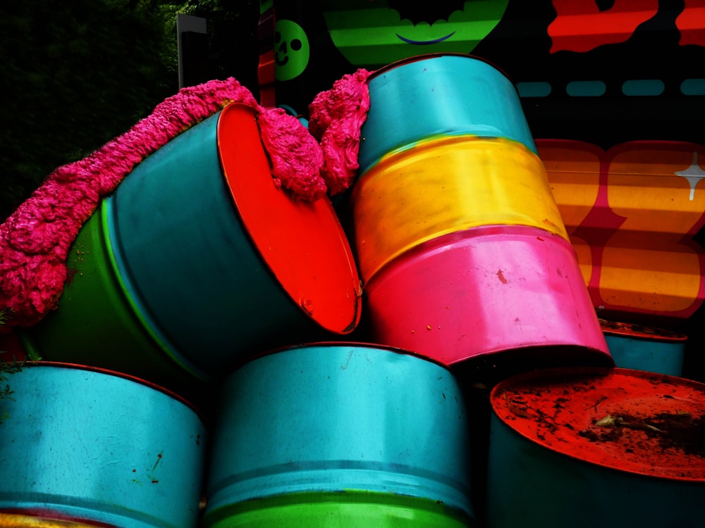 a bunch of colorful buckets stacked on top of each other