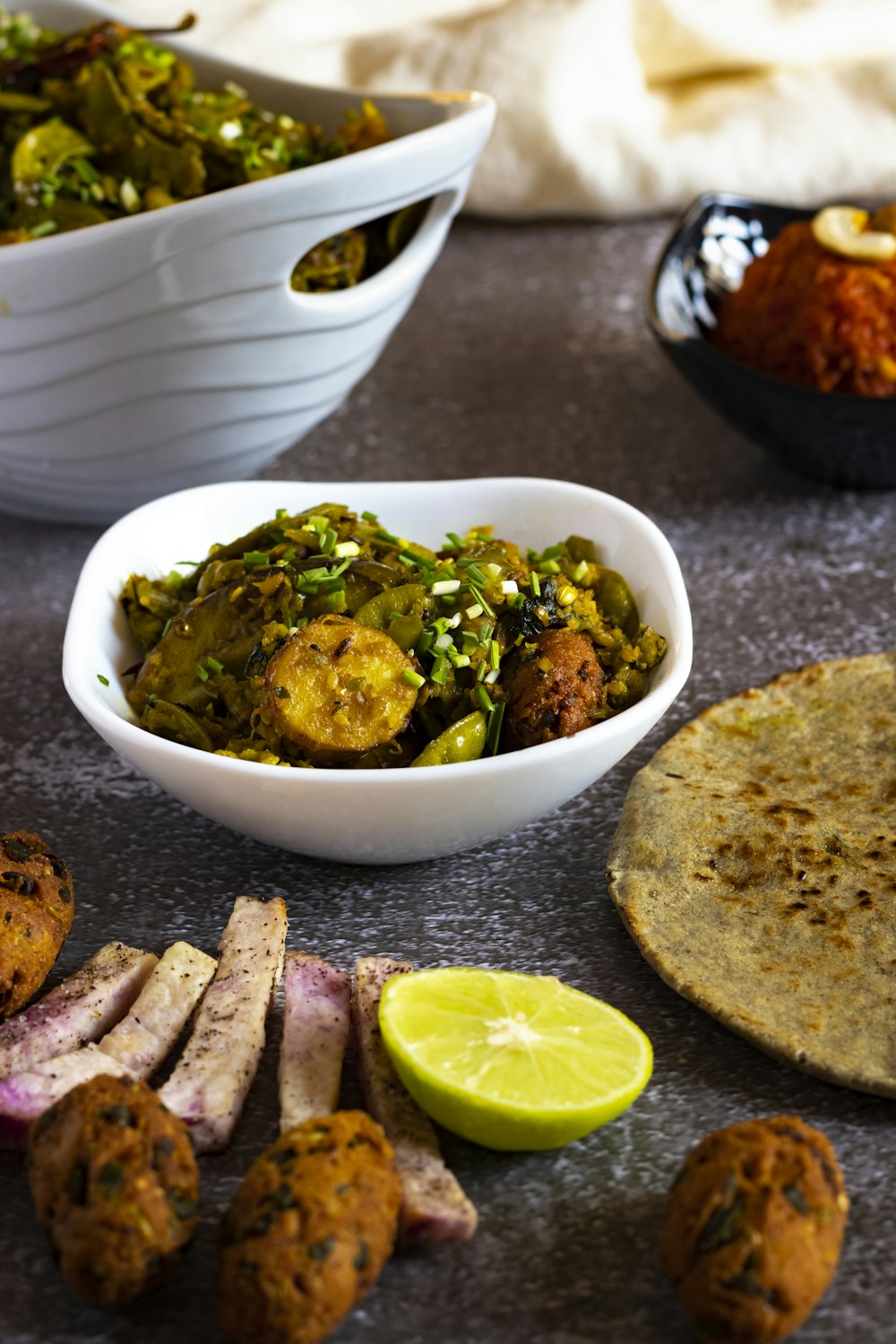 a table topped with bowls of food and a tortilla