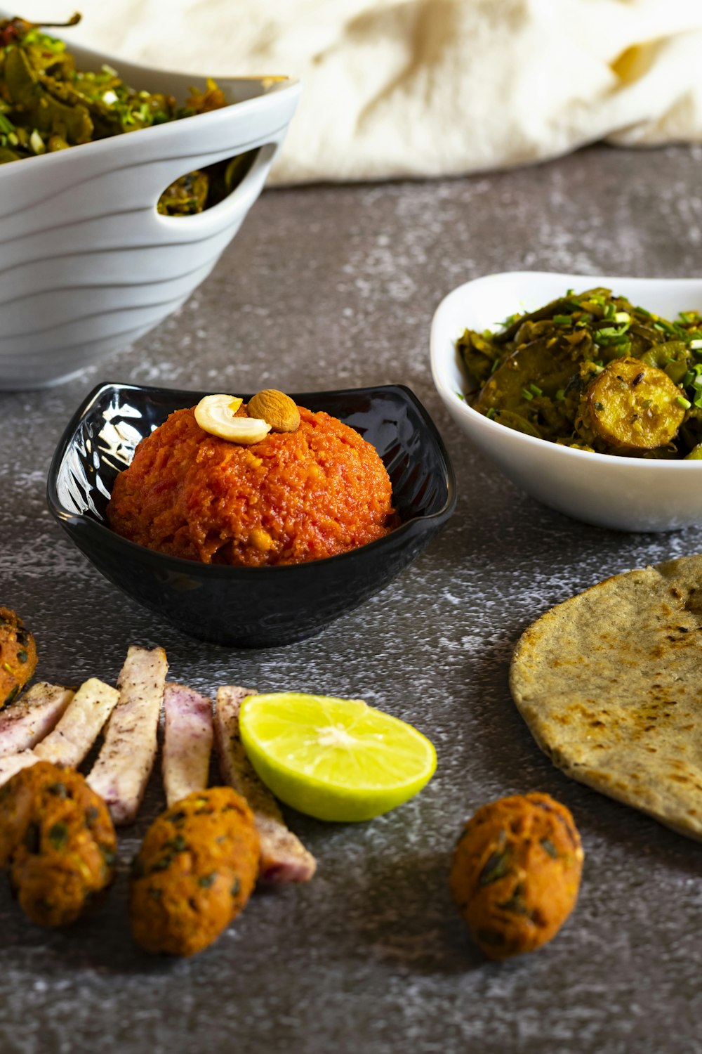 a table topped with bowls filled with food