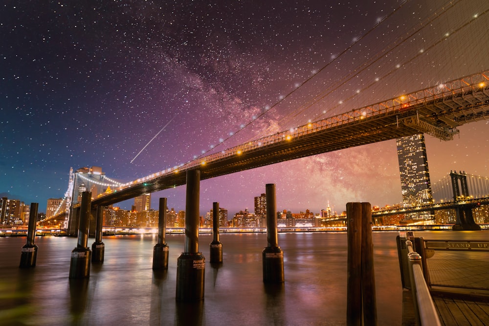 a night view of a bridge and a city