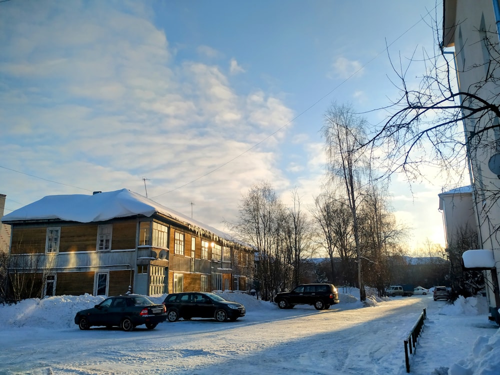 cars parked on the side of a snow covered road