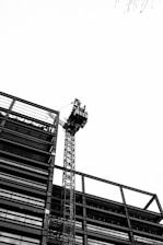 a tall tower with a crane on top of it