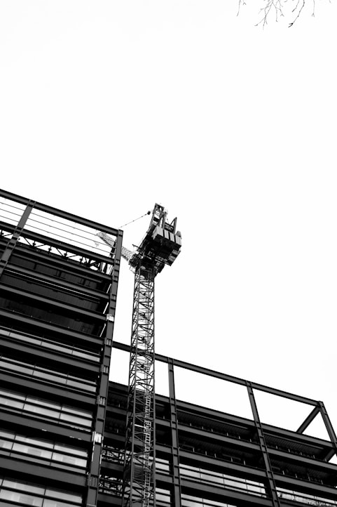 a tall tower with a crane on top of it