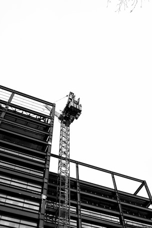 a tall tower with a crane on top of it