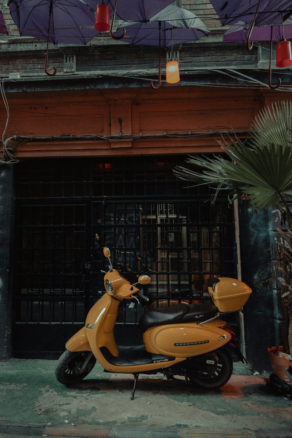 a yellow scooter parked in front of a building