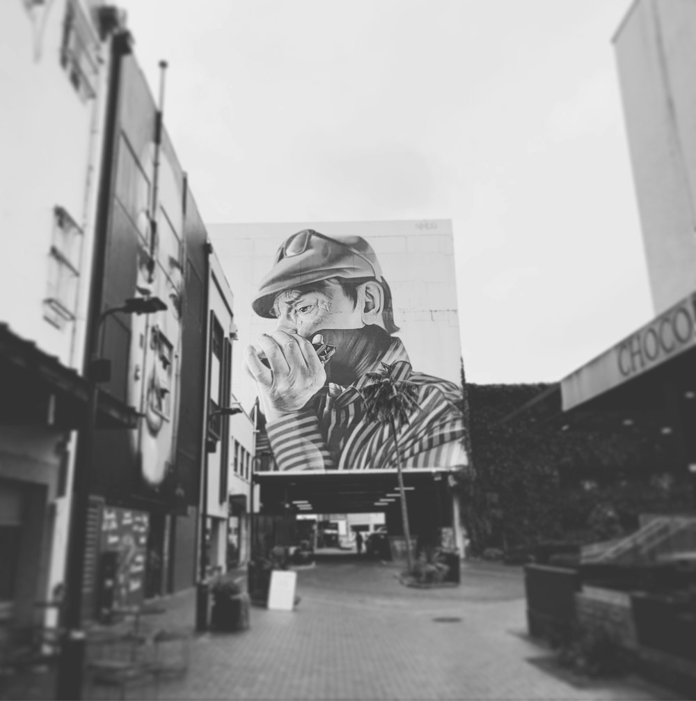 a black and white photo of a man on a billboard