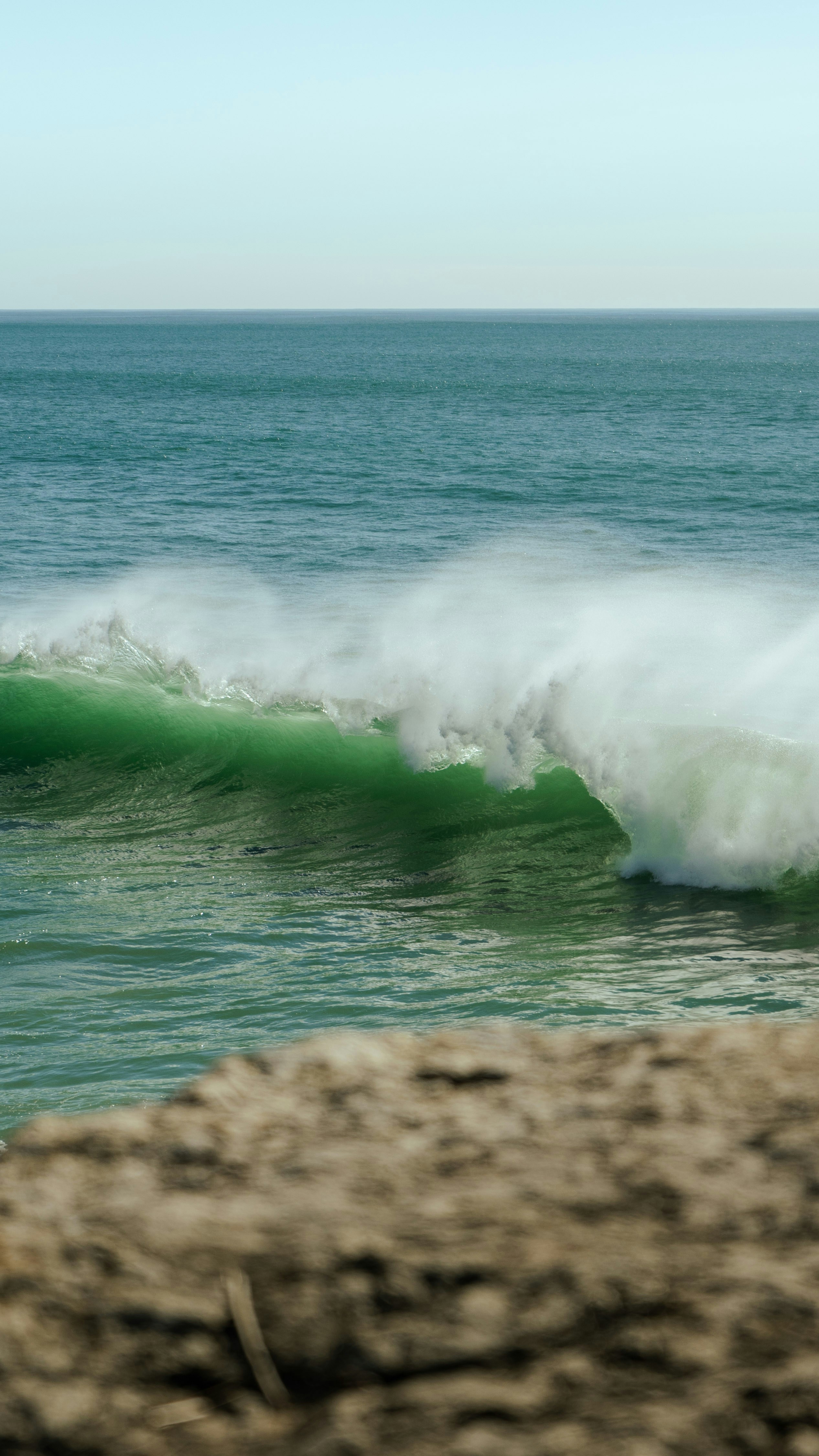 a man riding a wave on top of a surfboard