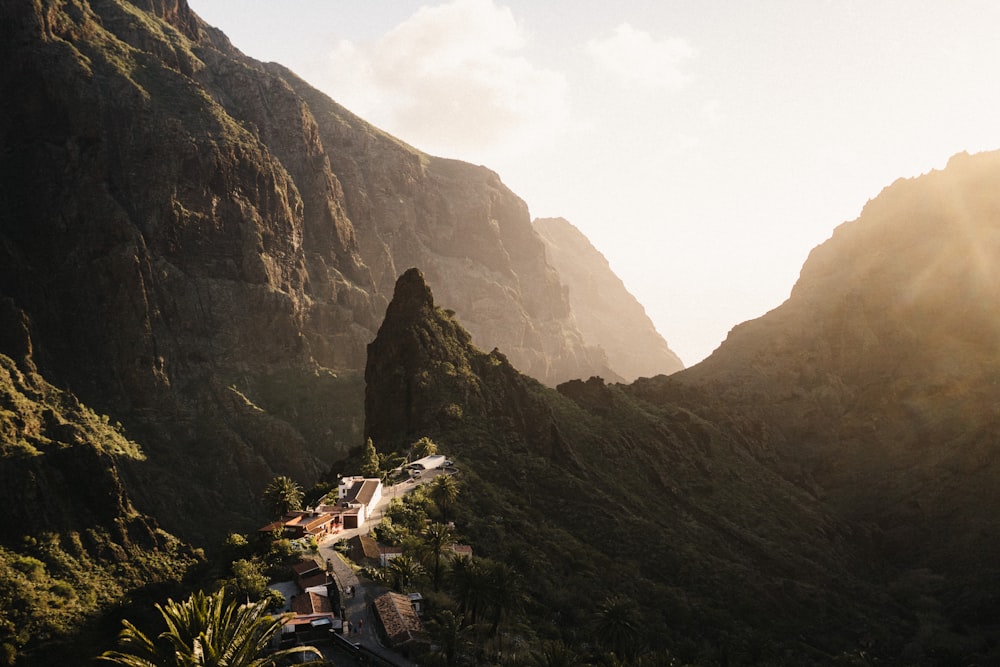 a scenic view of a mountain with a village in the foreground