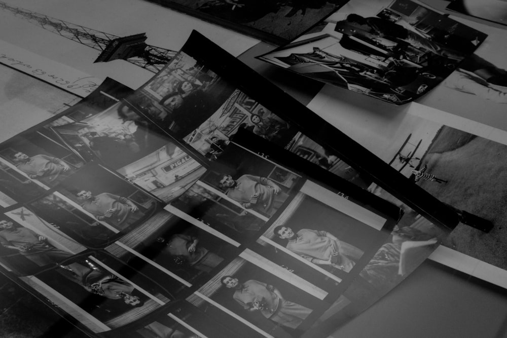 a bunch of black and white photos on a table