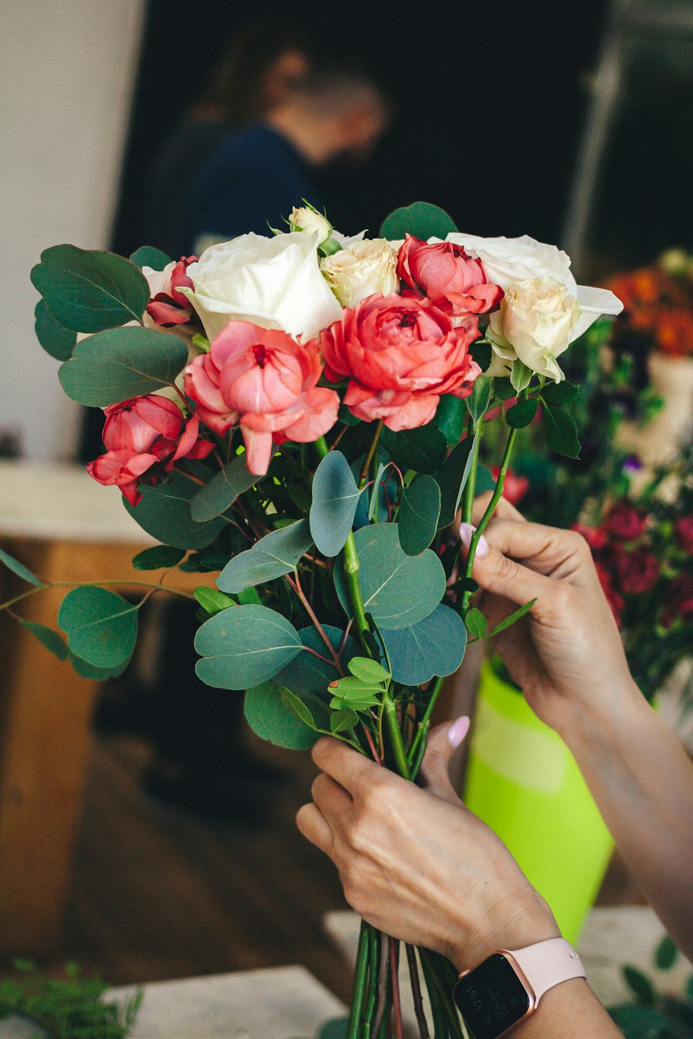 a person holding a bouquet of flowers in their hands