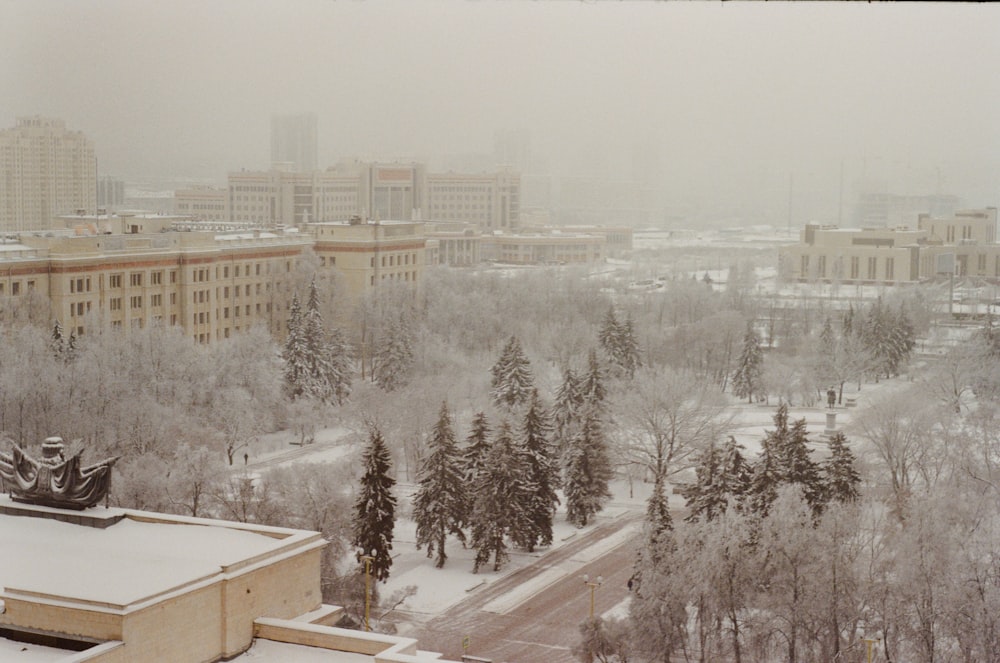 a view of a snowy city from a tall building