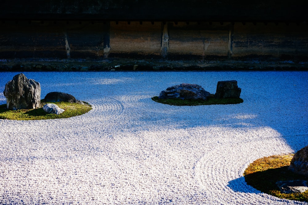 a rock garden in the middle of a graveled area