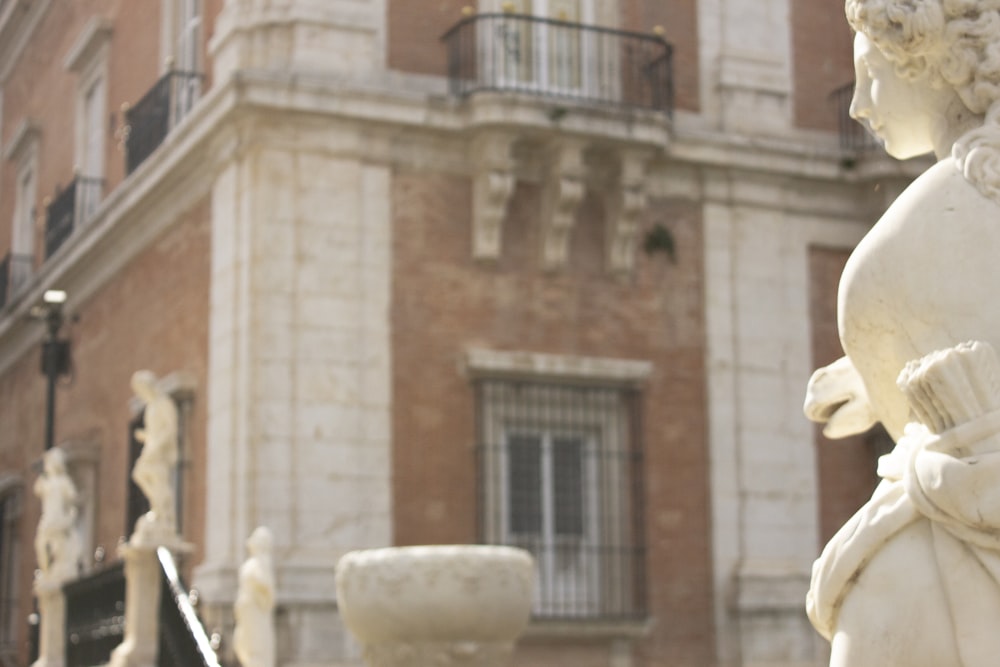 a statue of a woman in front of a building