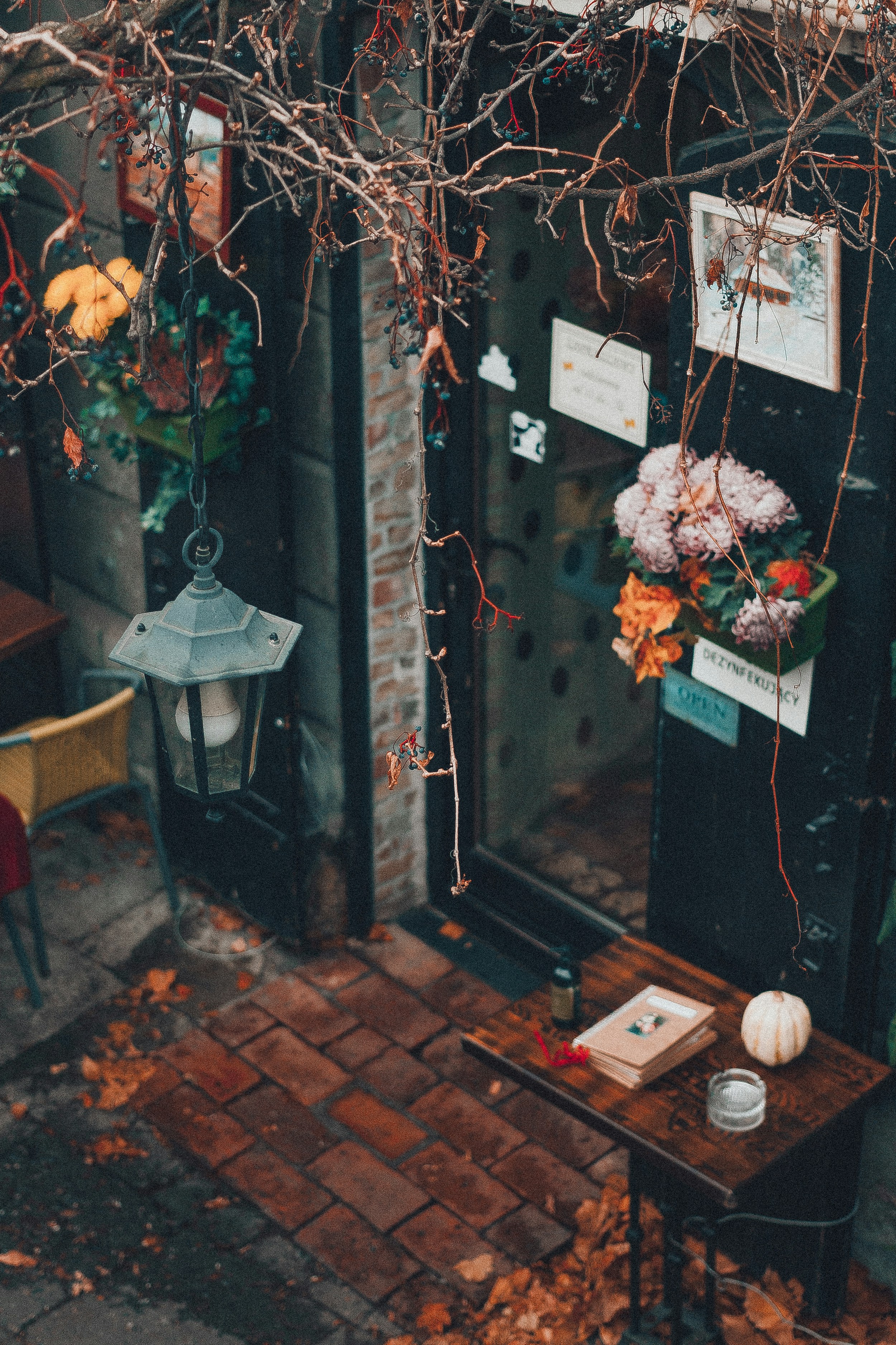 a small table with flowers on it in front of a building