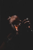 Hands holding a glowing orb of energy surrounded by ancient runes