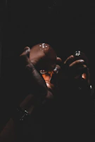 Hands holding a glowing orb surrounded by zodiac symbols in a mystical setting.