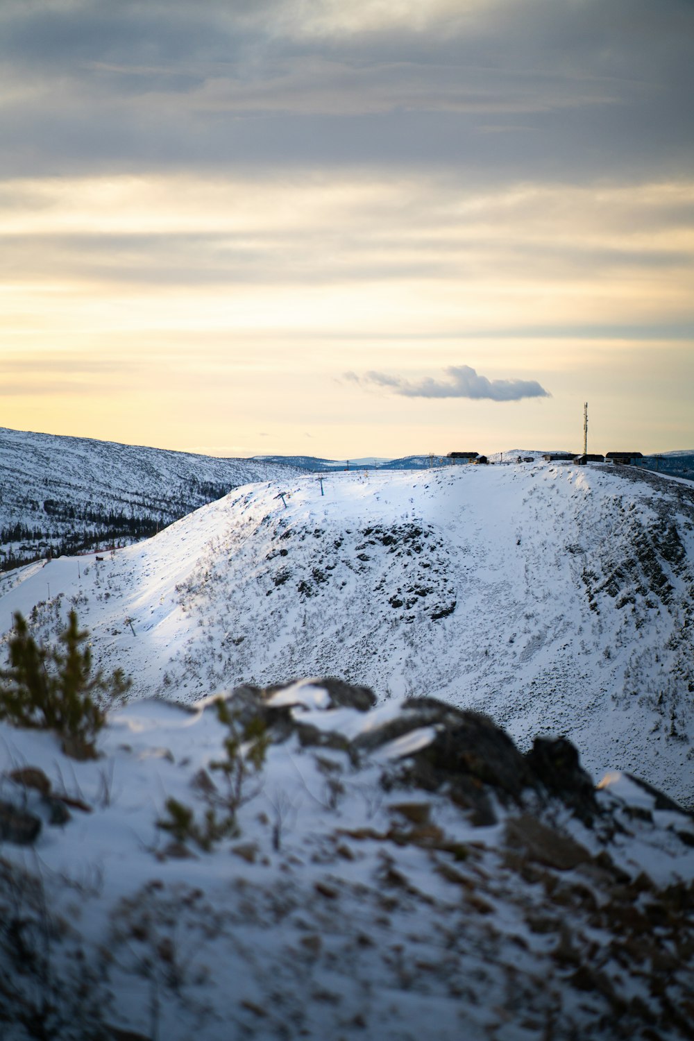 a hill covered in snow with a sky background