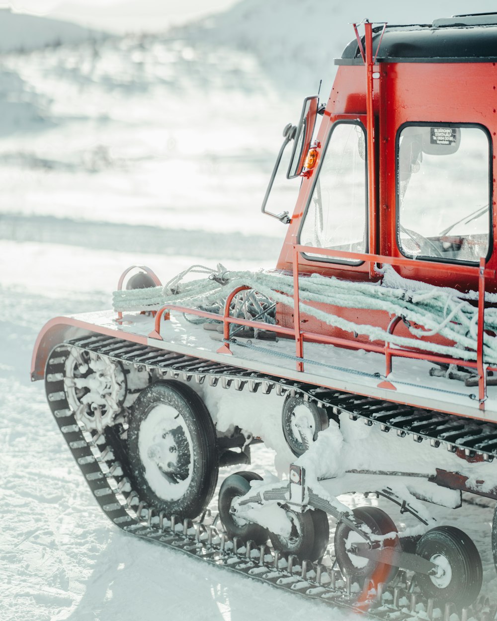 a red and black snowmobile in the snow