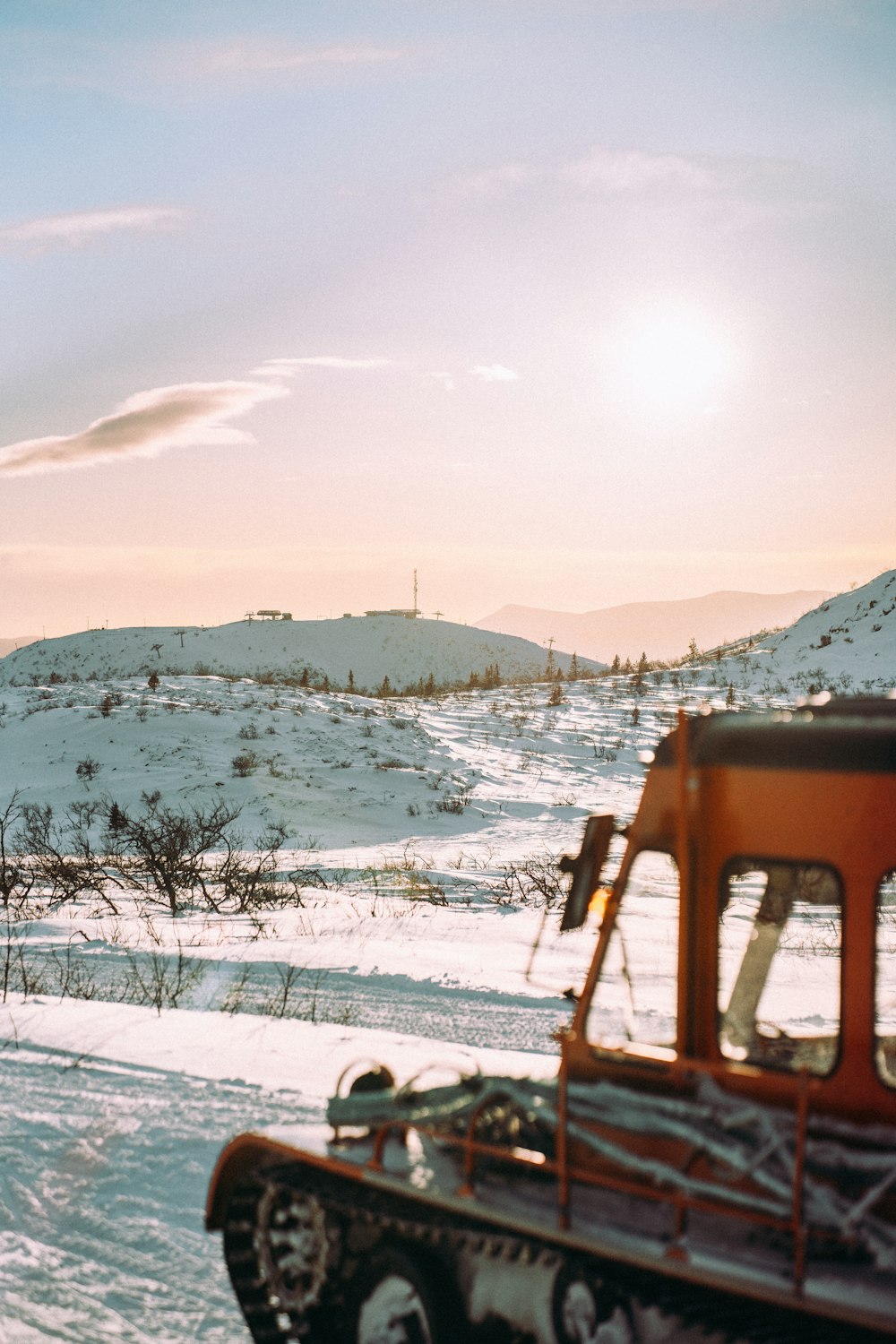 a truck driving through a snow covered field