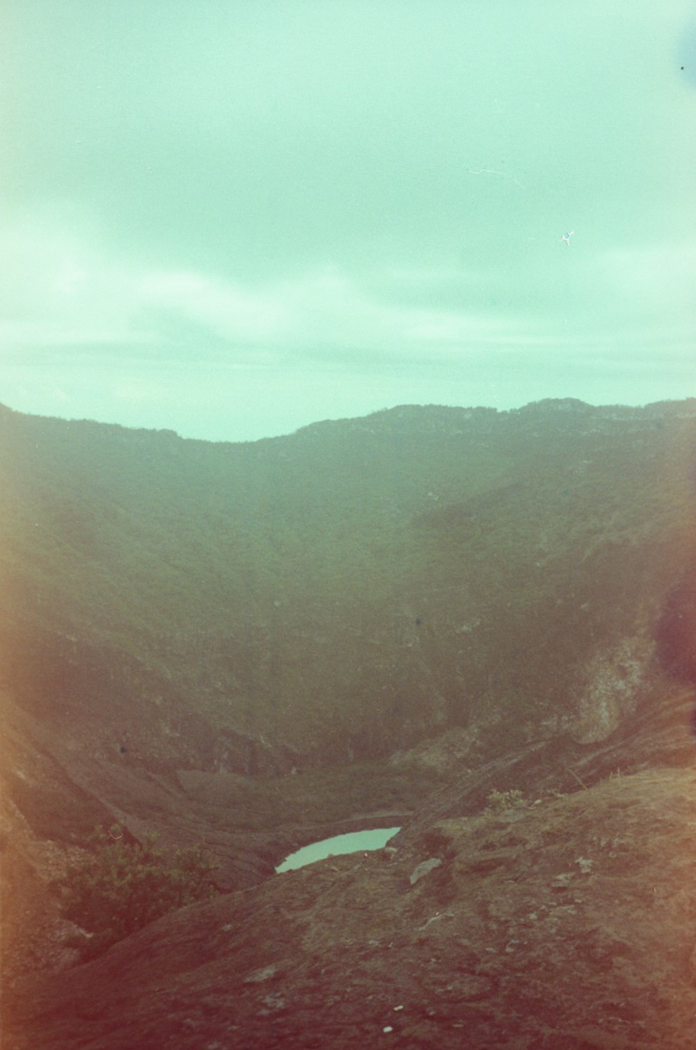 a mountain with a lake in the middle of it