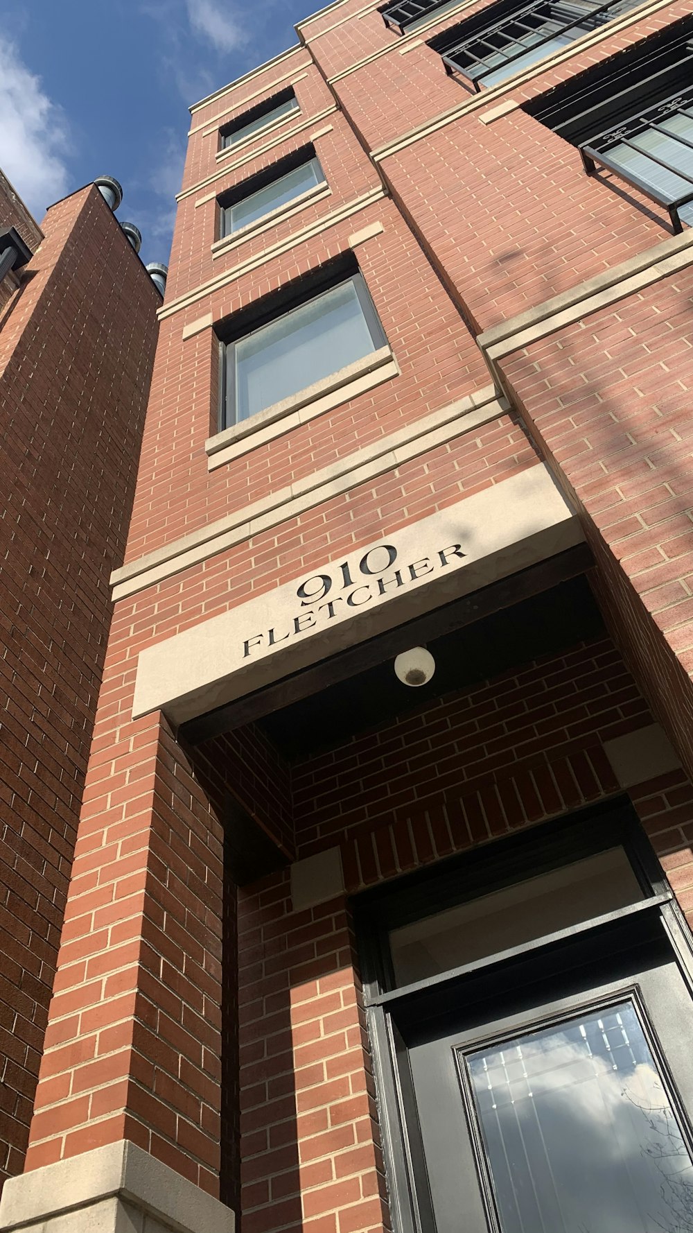 a tall brick building with a clock on it's side