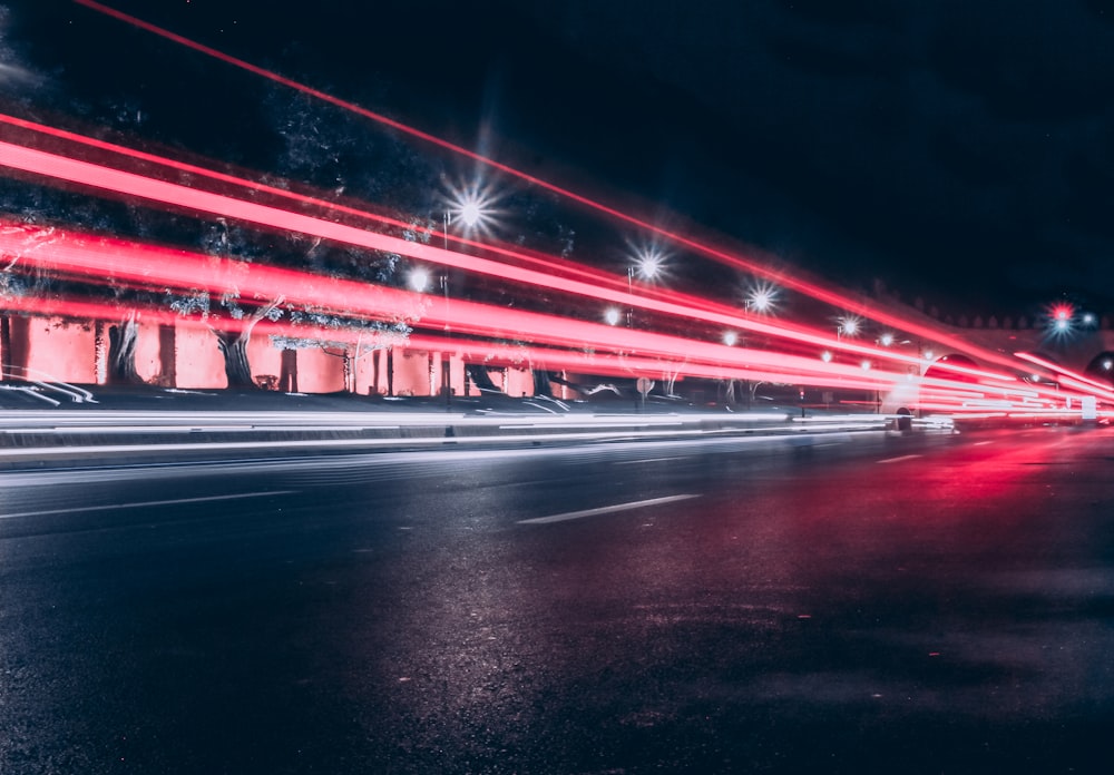 a long exposure photo of a city street at night