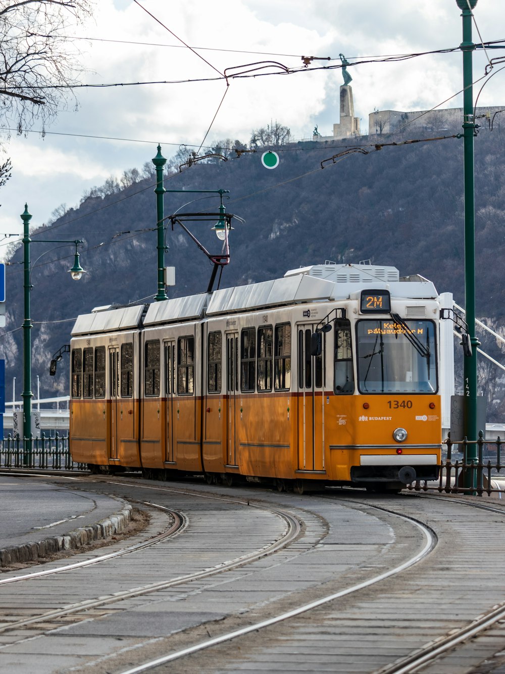 a yellow and white train traveling down train tracks