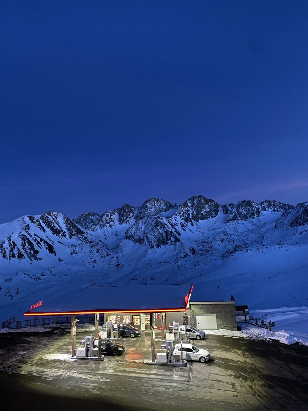 a gas station with mountains in the background