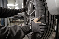 a man working on a tire in a garage