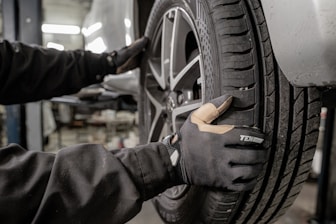 a man working on a tire in a garage