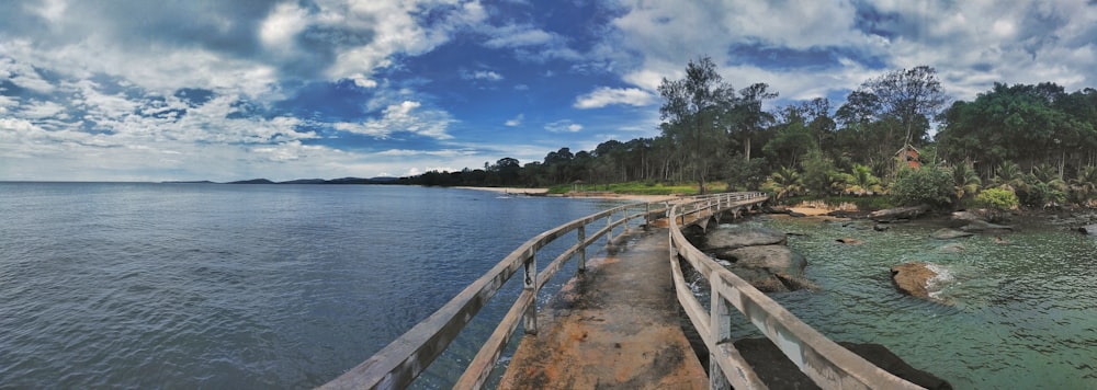 a long wooden bridge over a large body of water